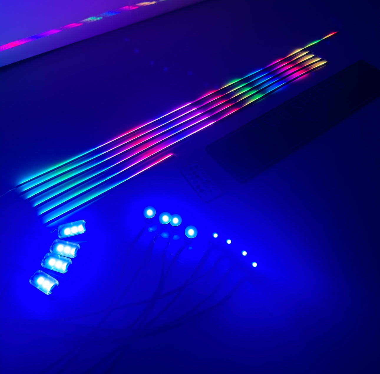 “Universal Ambient Lighting Kit RGB LED strips, modules and RF remote glowing blue for car interior accent lighting”